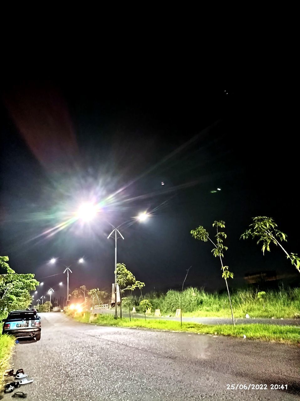 night, light, transportation, street, road, street light, illuminated, lighting, motor vehicle, car, mode of transportation, city, nature, plant, green, no people, sky, land vehicle, darkness, vehicle, lens flare, outdoors, architecture, lighting equipment, tree, the way forward