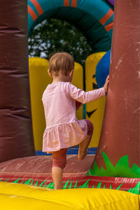 Little girl on a bouncy castle in the playground