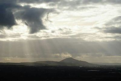 Scenic view of mountains against cloudy sky