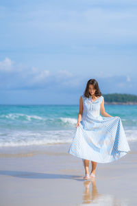 Woman on beach against sky