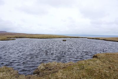 Scenic view of sea against cloudy sky