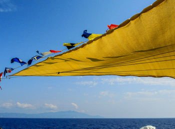 Low angle view of flag against blue sky