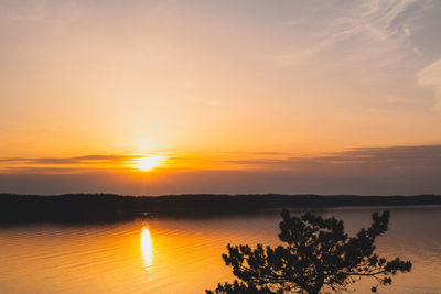 Scenic view of lake against romantic sky at sunset