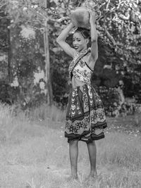 Portrait of a girl standing on field