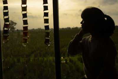 Side view of a boy standing on field