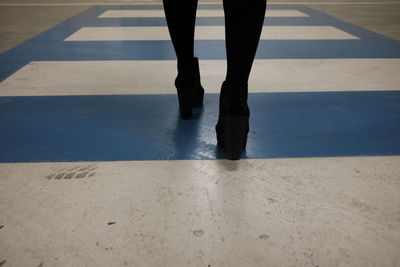 Low section of woman walking on floor