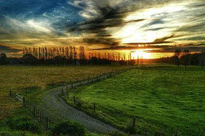 Scenic view of field against cloudy sky