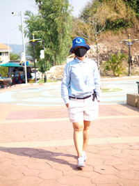 Rear view of man walking on road