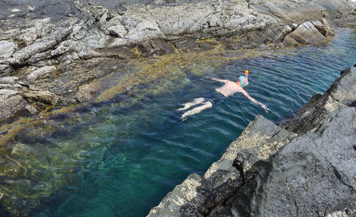 High angle view of people swimming in sea