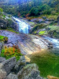 Scenic view of river flowing through rocks