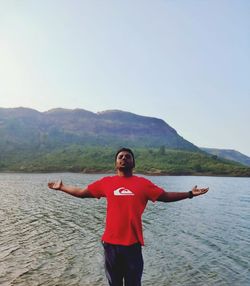 Full length of man standing on mountain against sky