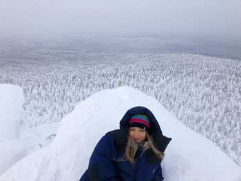 Portrait of man with snow covered mountain