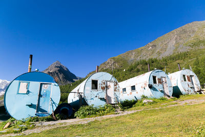 Built structure on field against clear blue sky