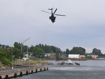 Commercial dock by river against sky