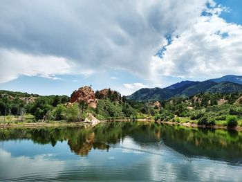 Scenic view of lake by trees against sky