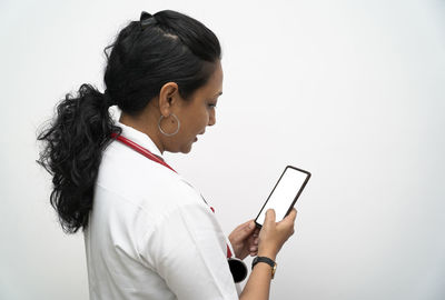 Side view of woman using mobile phone