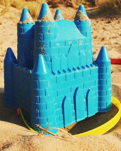 Close-up of blue sandcastle bucket in sand of ainsdale beach