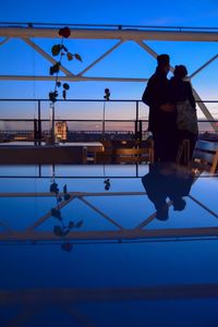 Low angle view of person walking against clear sky