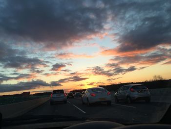 Road against cloudy sky at sunset