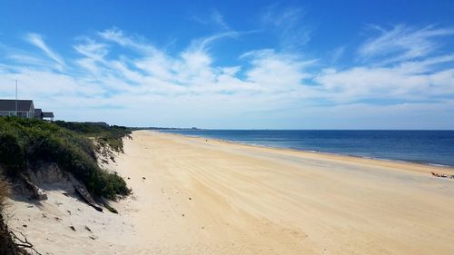 Scenic view of beach against blue sky