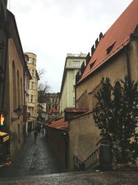 Alley amidst buildings in town against sky