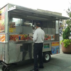 Woman standing by wall