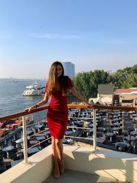 Full length of woman standing against sky