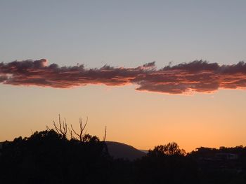 Scenic view of silhouette landscape against romantic sky at sunset