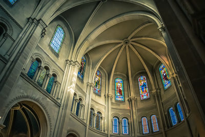 Low angle view of stained glass window in building