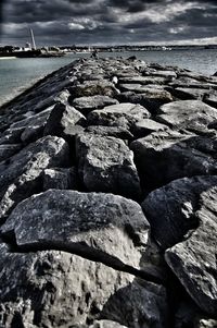 Rocks on beach against sky