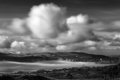 Scenic view of storm clouds over landscape