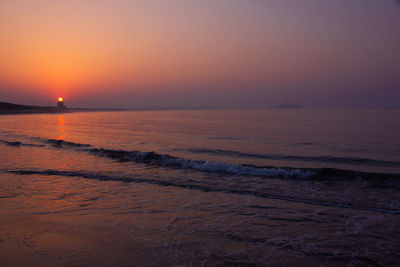 Scenic view of sea against romantic sky at sunset