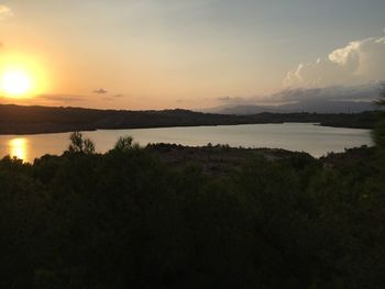 Scenic view of lake against sky during sunset