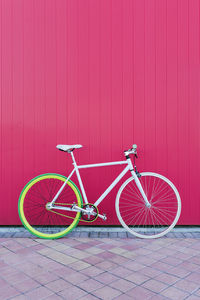 Bicycle parked against wall