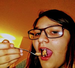 Portrait of young woman eating food