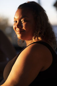 Side view portrait of smiling voluptuous woman