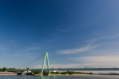 View of suspension bridge against cloudy sky