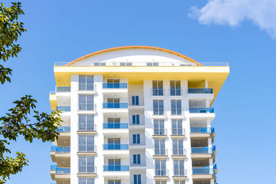 View of a beautiful residential building against the blue sky and greenery. new uninhabited house.