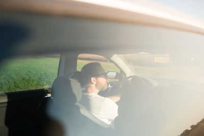 Man sitting in car