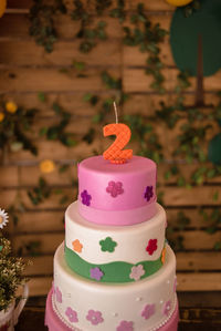 Close-up of birthday cake with candle showing te number 2