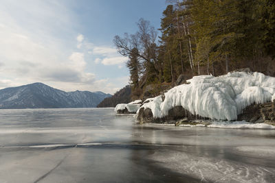 View of beautiful drawings on ice from cracks on the surface of lake teletskoye in winter, russia