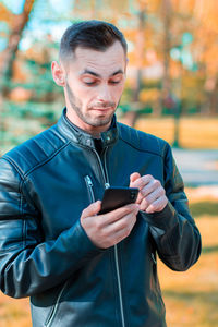 Mid adult man using mobile phone