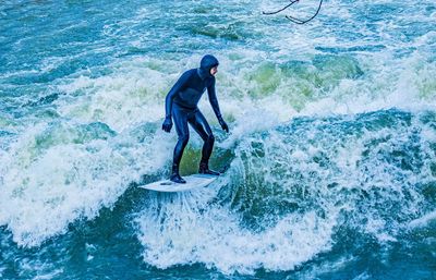 Full length of man surfing on sea shore