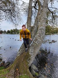 Full length of woman standing by lake