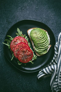 High angle view of avocado on toasted bread in plate