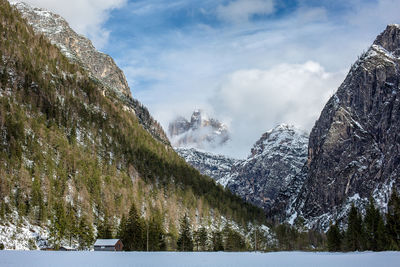 Panoramic view of snowcapped mountains and lake against sky