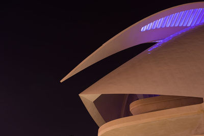 Low angle view of illuminated building against blue sky