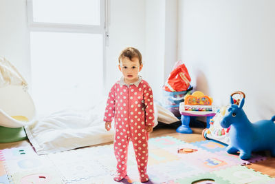 Cute girl playing with toy at home