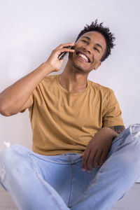 Young woman using mobile phone at home