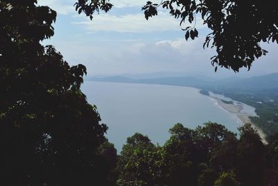 Scenic view of sea and mountains against sky